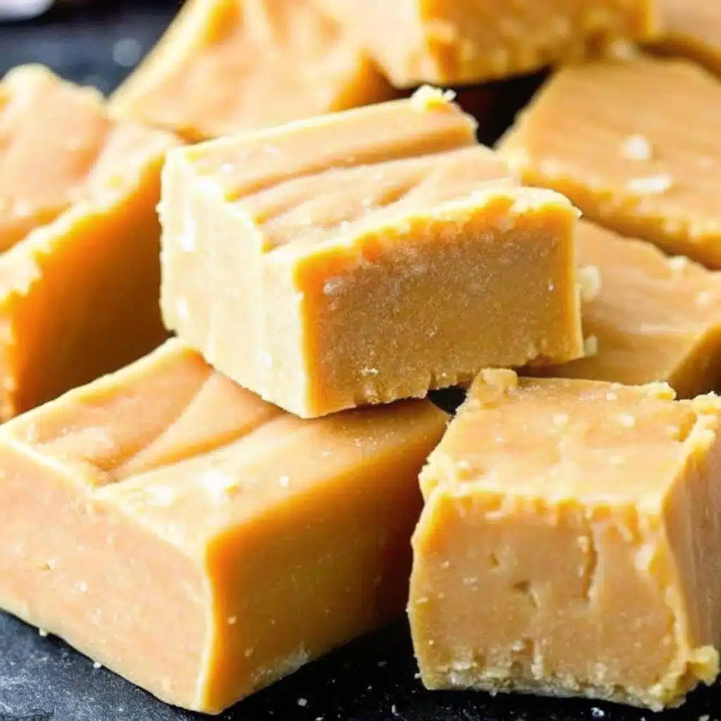 3 Ingredient Peanut Butter Fudge That Melts in Your Mouth 1 Close-up of creamy 3 ingredient peanut butter fudge squares stacked on a dark surface